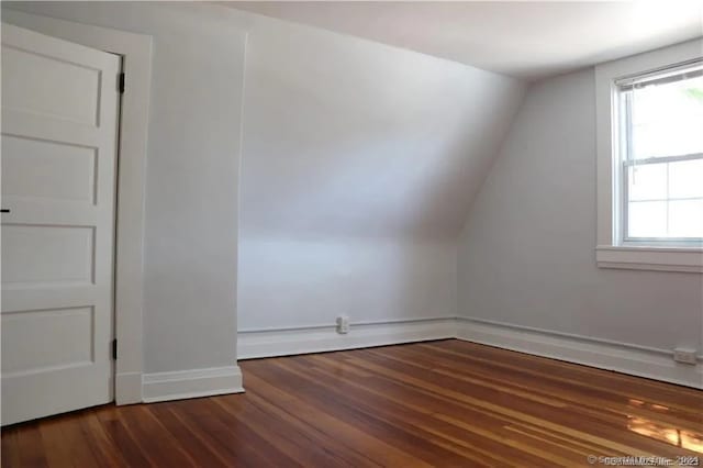 bonus room with dark hardwood / wood-style flooring and lofted ceiling