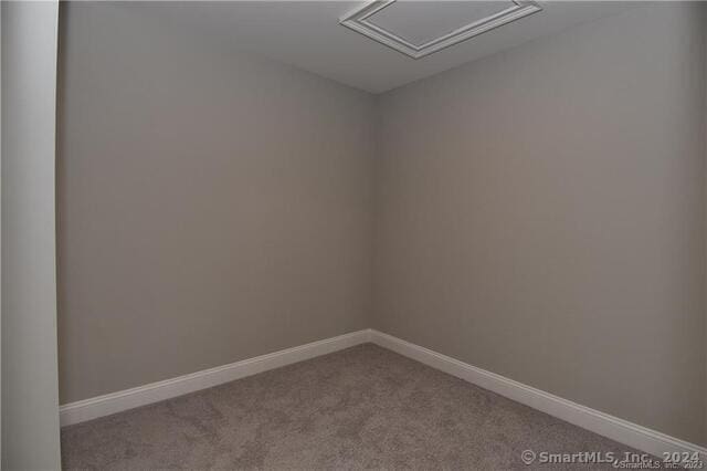 unfurnished room with baseboards and carpet floors