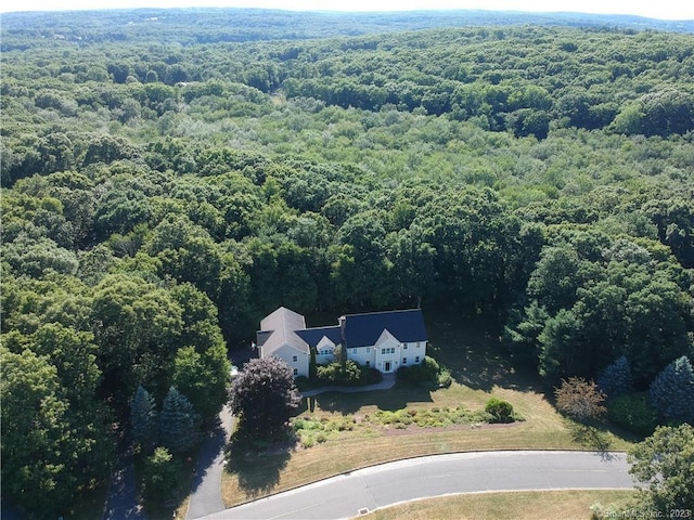 drone / aerial view featuring a view of trees