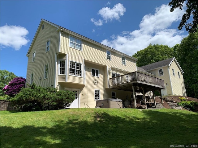 back of property featuring a deck and a yard