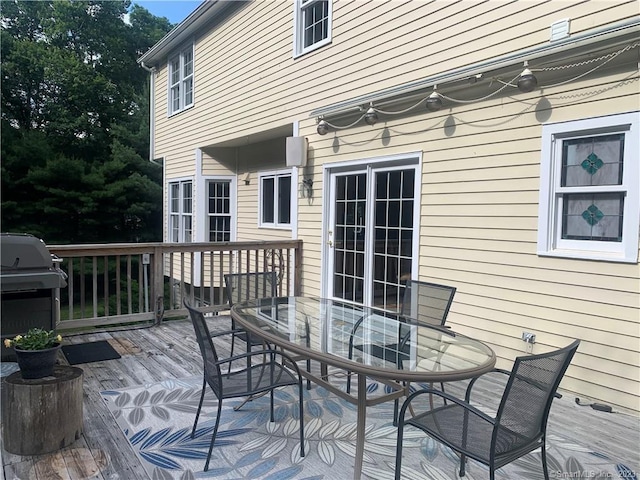 wooden terrace featuring area for grilling