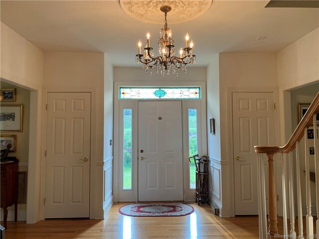 foyer entrance featuring a chandelier and light hardwood / wood-style flooring