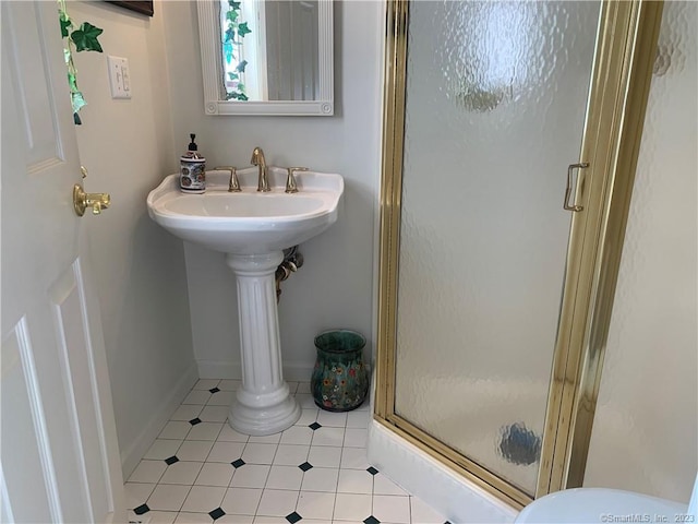 bathroom with walk in shower, toilet, and tile floors