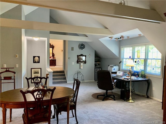 dining area featuring carpet and lofted ceiling