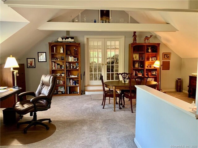 carpeted office with french doors and lofted ceiling