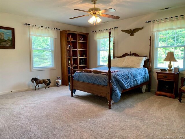 bedroom with ceiling fan and carpet floors