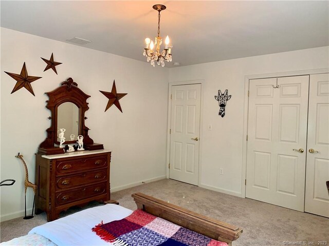 bedroom featuring carpet and a chandelier