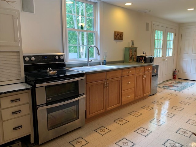 kitchen with sink, electric stove, and light tile flooring