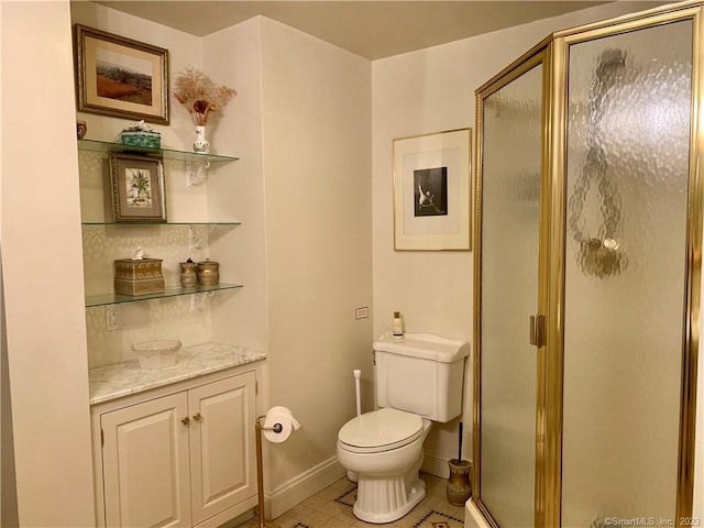 bathroom with tile flooring, oversized vanity, toilet, and a shower with door