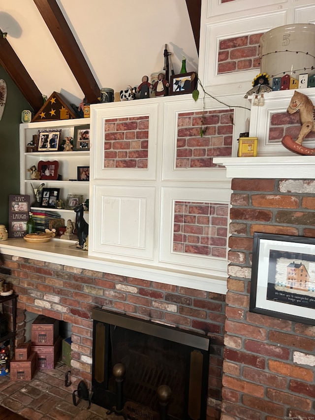 interior details featuring beamed ceiling and a fireplace