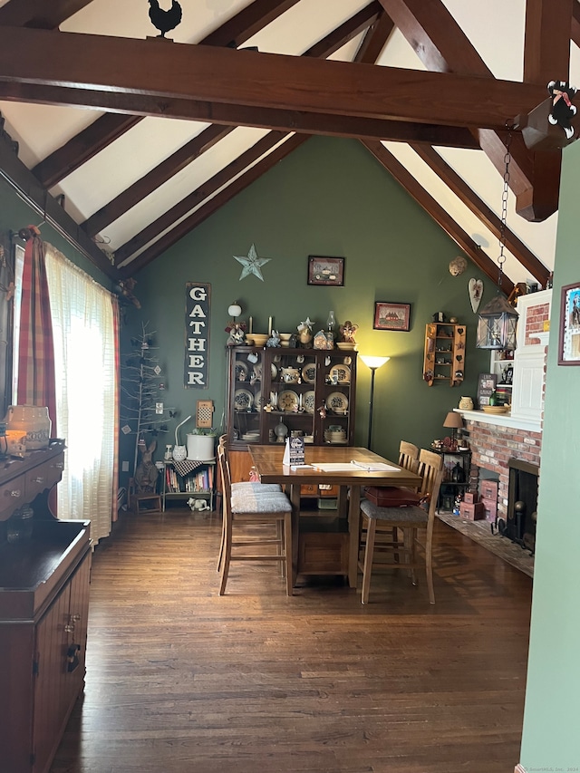 dining space with high vaulted ceiling, beam ceiling, dark wood-type flooring, and a brick fireplace