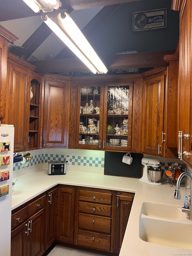 kitchen featuring tasteful backsplash, sink, and white refrigerator