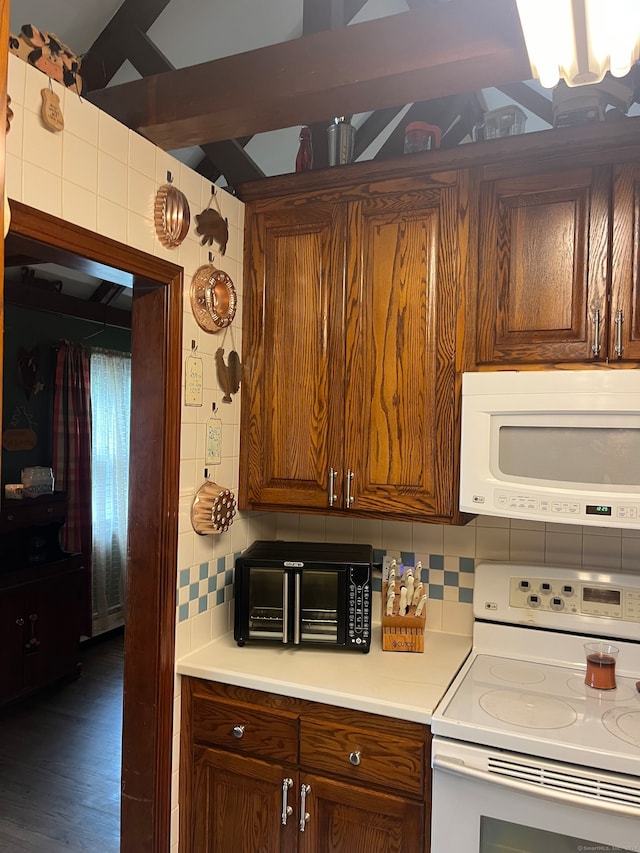 kitchen with decorative backsplash, white appliances, beam ceiling, and dark hardwood / wood-style flooring