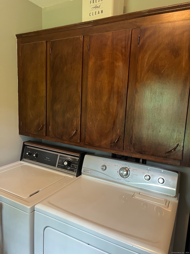 laundry area featuring cabinets and washing machine and dryer