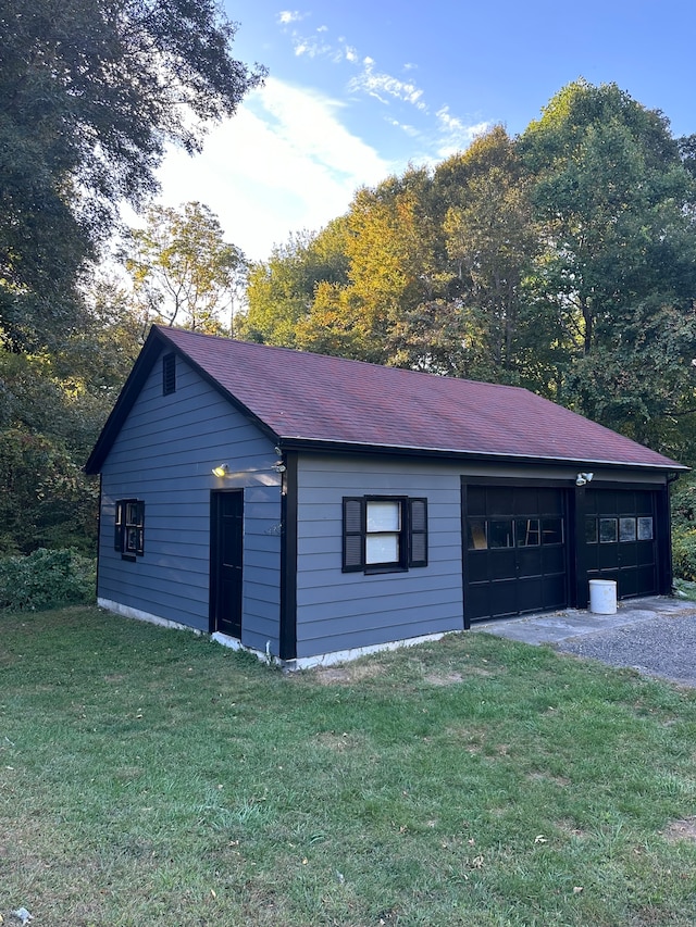 garage with wood walls and a yard