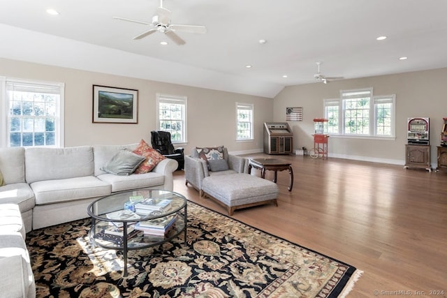 living room featuring ceiling fan, hardwood / wood-style flooring, vaulted ceiling, and a healthy amount of sunlight