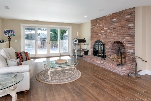 living room with dark hardwood / wood-style floors and french doors