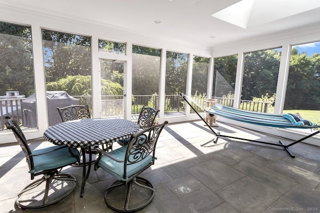 sunroom with plenty of natural light and a skylight