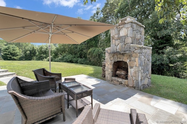 view of patio / terrace with an outdoor stone fireplace