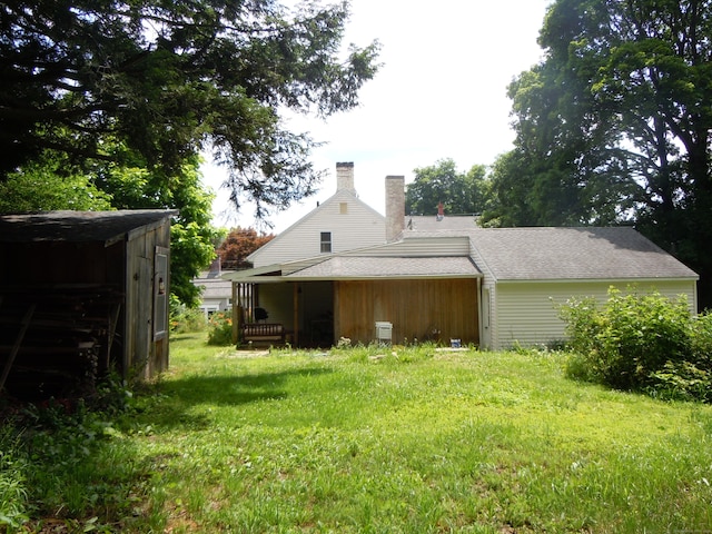 back of property with a lawn