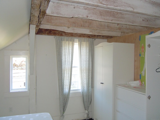 unfurnished bedroom featuring vaulted ceiling and multiple windows