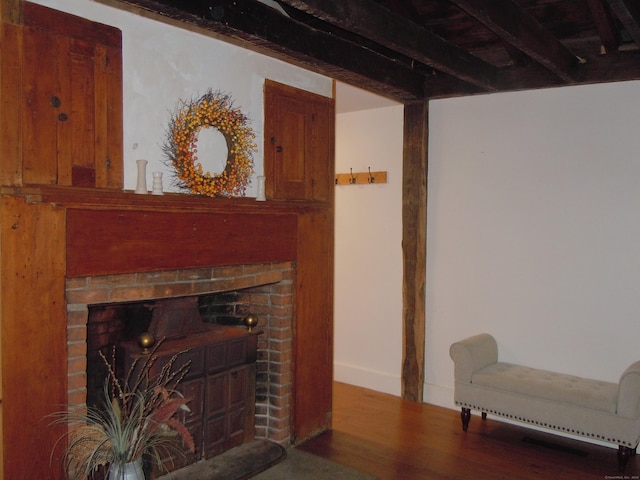 living room featuring a brick fireplace and hardwood / wood-style flooring