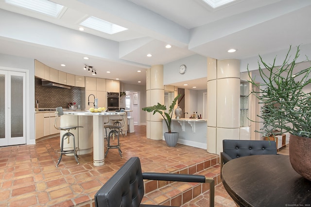 interior space with a skylight and light tile patterned floors