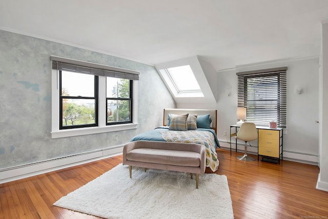 bedroom with a skylight, wood-type flooring, and a baseboard heating unit