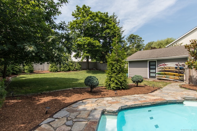 view of swimming pool featuring a lawn