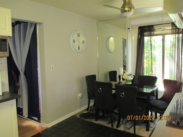 dining space with wood-type flooring and ceiling fan