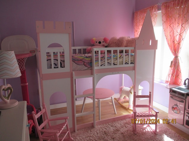 bedroom featuring multiple windows and hardwood / wood-style floors