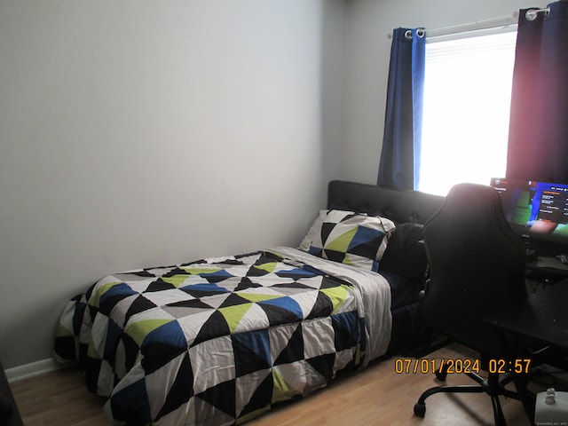 bedroom with hardwood / wood-style flooring