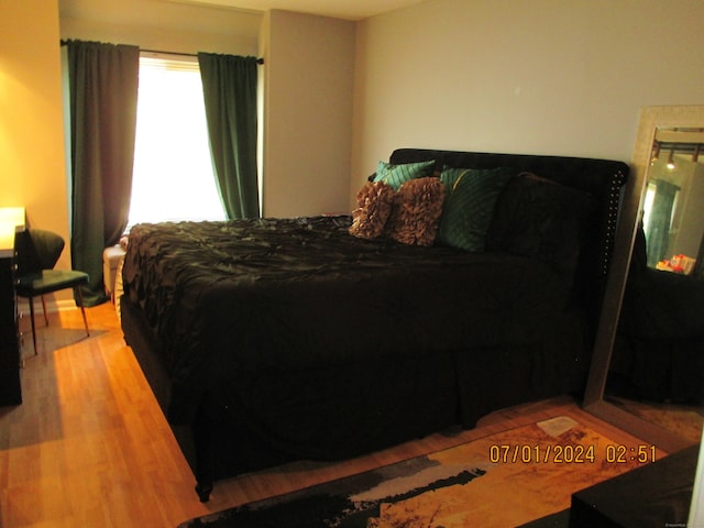 bedroom with hardwood / wood-style flooring