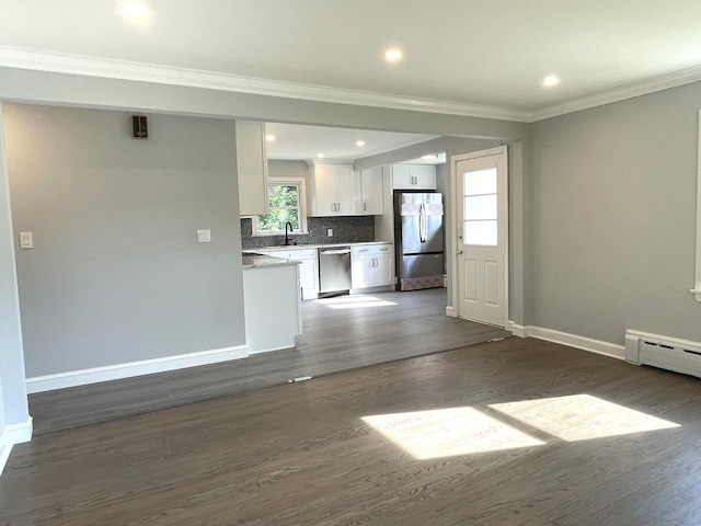 unfurnished living room with dark hardwood / wood-style flooring, sink, crown molding, and a baseboard heating unit