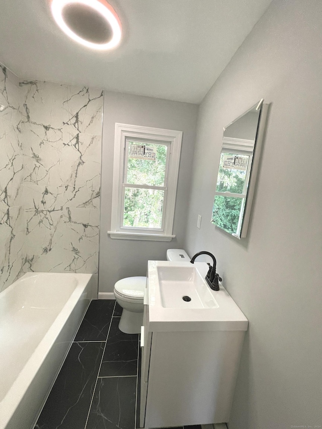 full bathroom featuring tiled shower / bath, vanity, and toilet