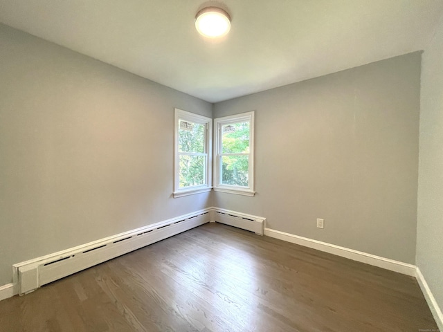 empty room with a baseboard radiator and wood-type flooring