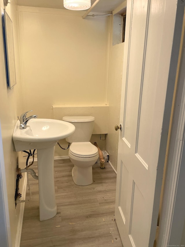 bathroom featuring hardwood / wood-style floors and toilet