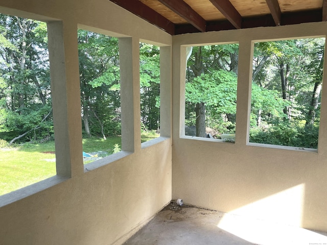 unfurnished sunroom with lofted ceiling with beams and wood ceiling