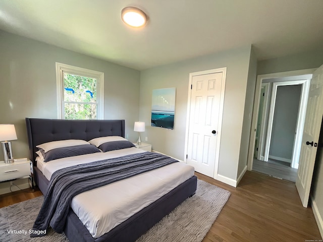 bedroom featuring dark wood-type flooring