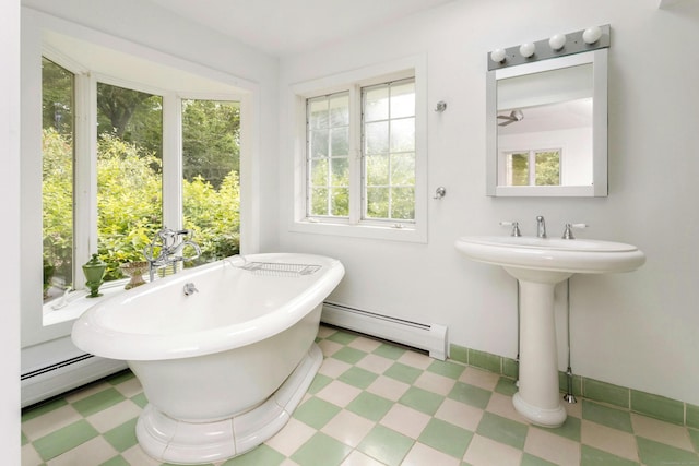 bathroom featuring a baseboard radiator and a tub to relax in