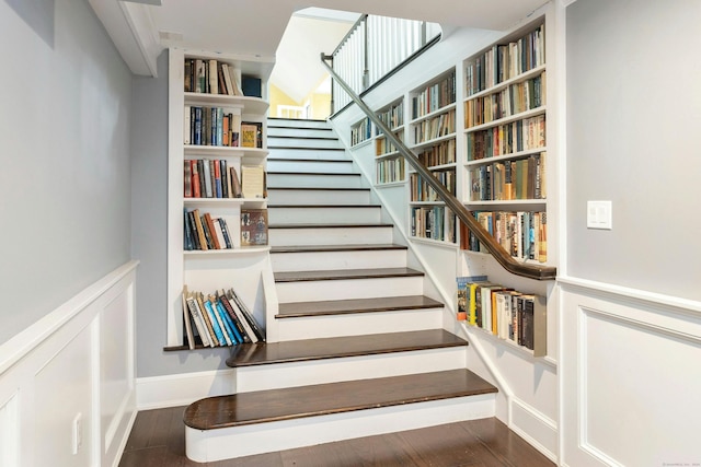 stairs featuring hardwood / wood-style floors