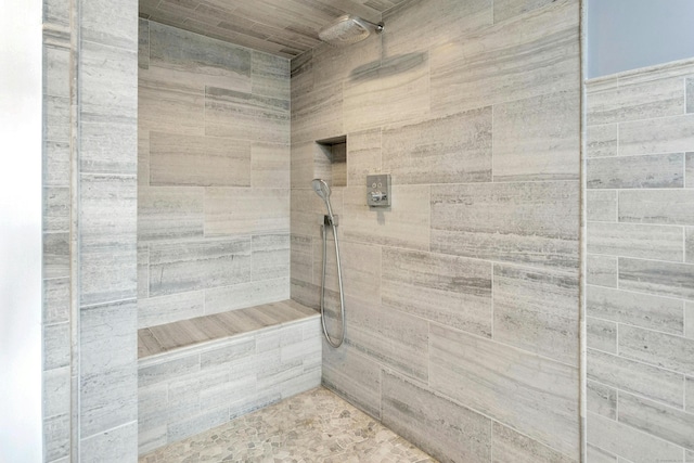 bathroom with a tile shower