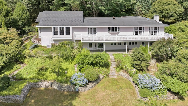 exterior space with a wooden deck and a lawn