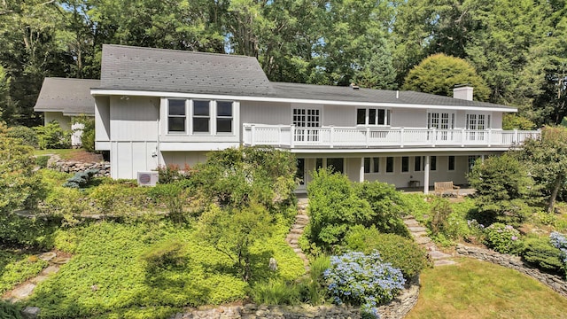 rear view of property with a deck and a patio