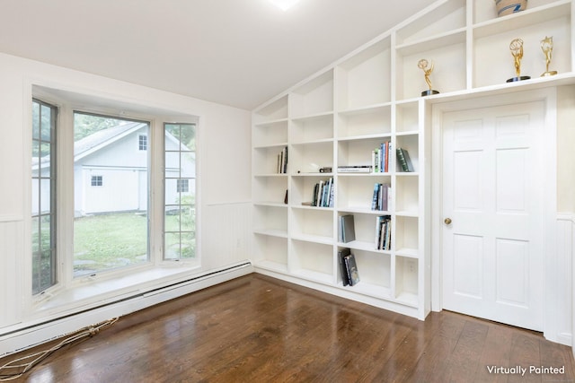 unfurnished room with a wealth of natural light, dark wood-type flooring, vaulted ceiling, and baseboard heating