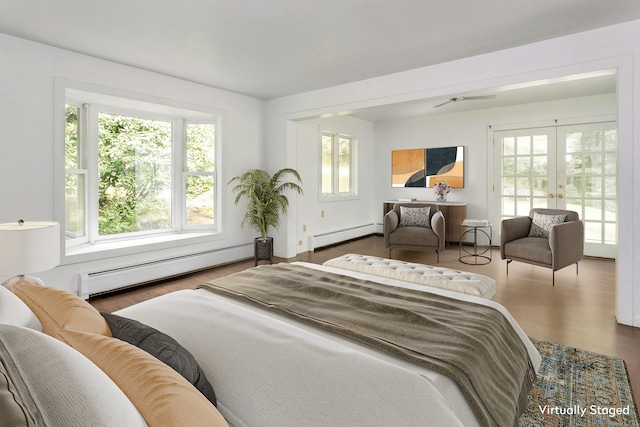 bedroom with baseboard heating, dark wood-type flooring, and french doors