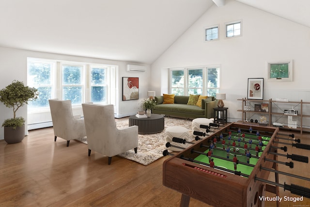 rec room featuring a wealth of natural light, an AC wall unit, hardwood / wood-style floors, and a baseboard radiator