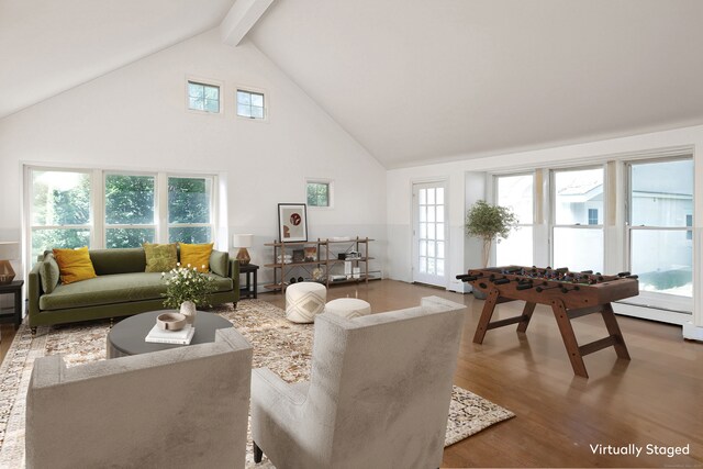 living room featuring hardwood / wood-style flooring, plenty of natural light, high vaulted ceiling, and beamed ceiling