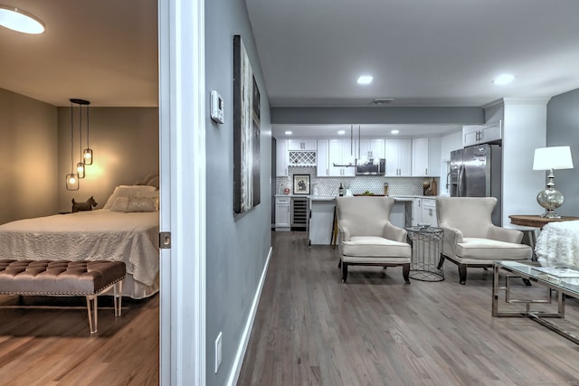 interior space with hardwood / wood-style floors and wine cooler