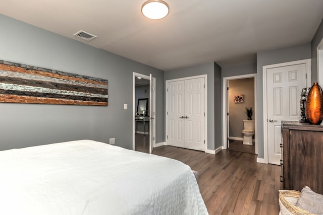 bedroom with ensuite bathroom and dark wood-type flooring